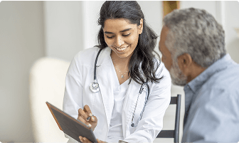 Female doctor talking with an elderly man