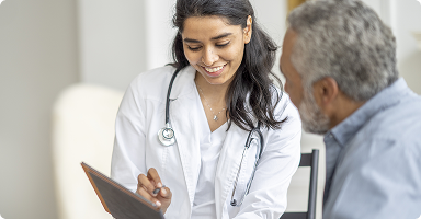 Female doctor talking with elderly man
