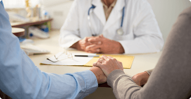 Doctor talking with a couple