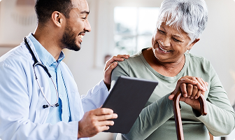 Doctor comforting elderly lady